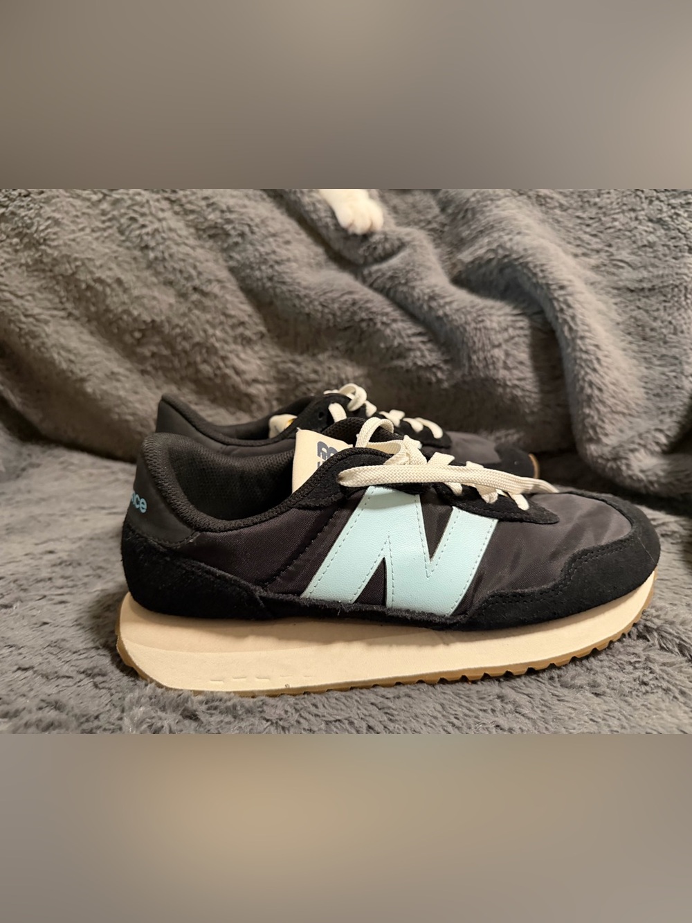 New Balance women’s Black Sneakers with Light Blue 'N' Logo
